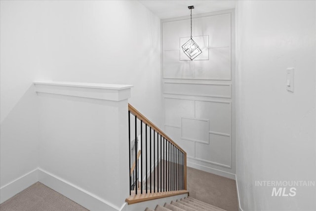 13625 Hickory Rnch, Nampa, ID 83651 - staircase featuring carpet floors, baseboards, and a chandelier