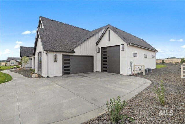 13625 Hickory Rnch, Nampa, ID 83651 - view of property exterior with roof with shingles, an attached garage, central AC, board and batten siding, and concrete driveway