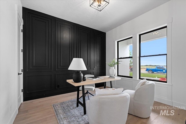 13625 Hickory Rnch, Nampa, ID 83651 - office area with light wood-type flooring, a decorative wall, and baseboards