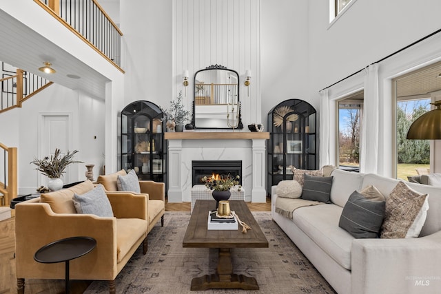 3031 Champagne Ct, Eagle, ID 83616 - living room with a towering ceiling, stairs, a high end fireplace, and wood finished floors