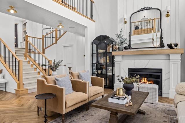 3031 Champagne Ct, Eagle, ID 83616 - living area featuring stairs, a high end fireplace, and a towering ceiling