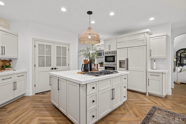 3031 Champagne Ct, Eagle, ID 83616 - kitchen with built in appliances, light countertops, white cabinets, and recessed lighting