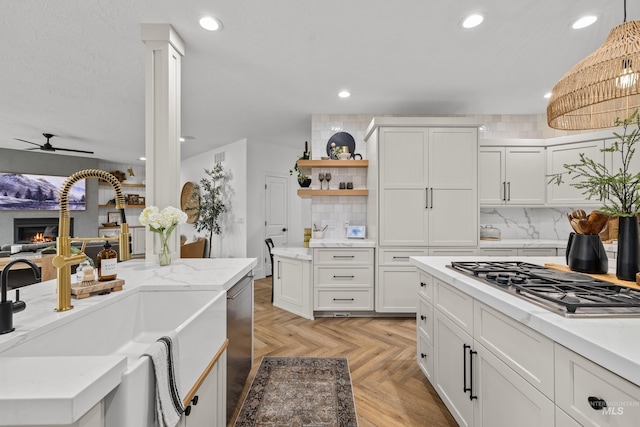 3031 Champagne Ct, Eagle, ID 83616 - kitchen featuring a sink, white cabinetry, ceiling fan, appliances with stainless steel finishes, and recessed lighting