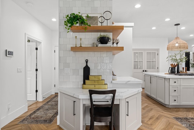 3031 Champagne Ct, Eagle, ID 83616 - kitchen featuring open shelves, stainless steel gas cooktop, recessed lighting, pendant lighting, and light stone countertops