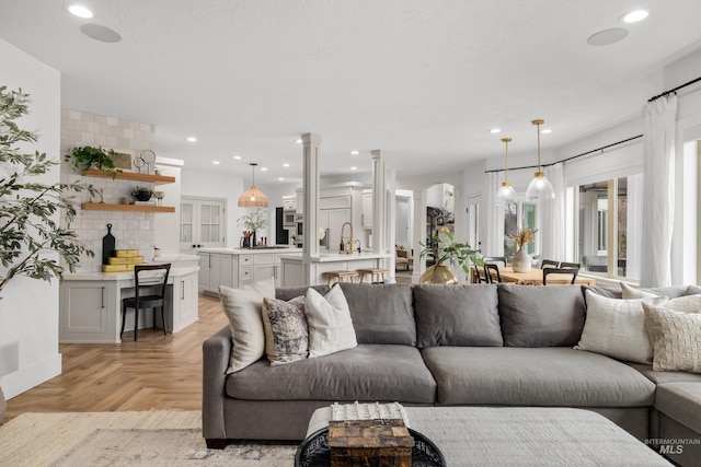 3031 Champagne Ct, Eagle, ID 83616 - living room featuring decorative columns, arched walkways, and recessed lighting