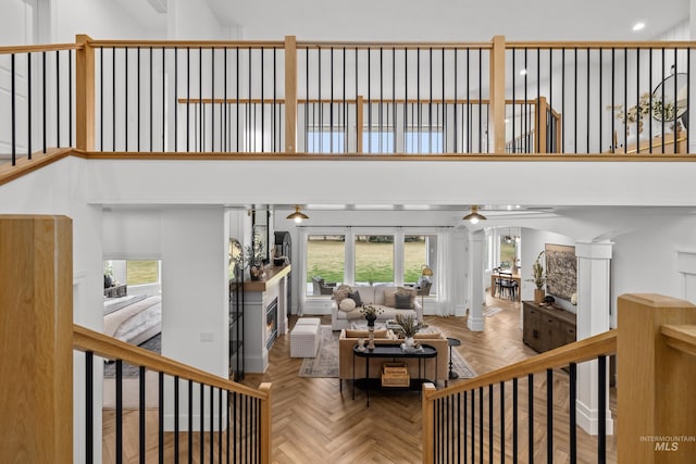 3031 Champagne Ct, Eagle, ID 83616 - living room with a lit fireplace, a towering ceiling, and recessed lighting
