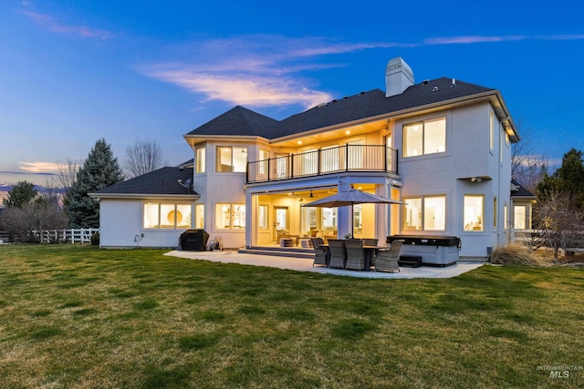 3031 Champagne Ct, Eagle, ID 83616 - rear view of house with a hot tub, a chimney, a patio, and a balcony