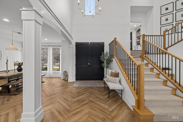 3031 Champagne Ct, Eagle, ID 83616 - entrance foyer with a high ceiling, stairs, arched walkways, a chandelier, and recessed lighting