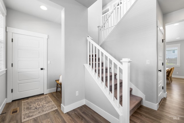 stairs featuring wood finished floors, baseboards, and recessed lighting