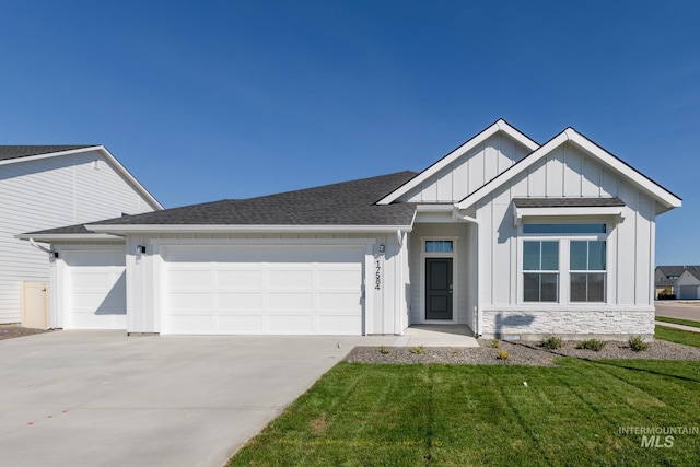 view of front of property with a front yard and a garage