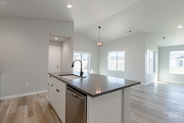 kitchen with stainless steel dishwasher, hanging light fixtures, sink, white cabinets, and a kitchen island with sink