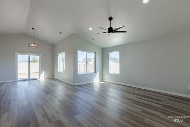 unfurnished room with hardwood / wood-style flooring, lofted ceiling, and ceiling fan with notable chandelier