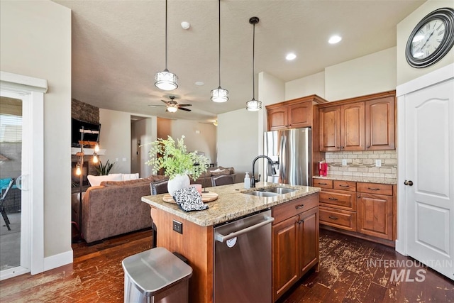 730 N Finsbury Way, Star, ID 83669 - kitchen featuring stainless steel appliances, open floor plan, light stone countertops, backsplash, and ceiling fan