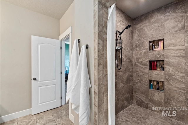 730 N Finsbury Way, Star, ID 83669 - bathroom featuring a tile shower and baseboards