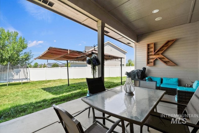 730 N Finsbury Way, Star, ID 83669 - fenced backyard featuring a trampoline, a patio area, and outdoor lounge area