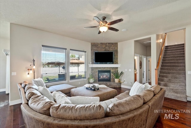 730 N Finsbury Way, Star, ID 83669 - living area featuring a ceiling fan, a fireplace, dark wood finished floors, stairs, and a textured ceiling