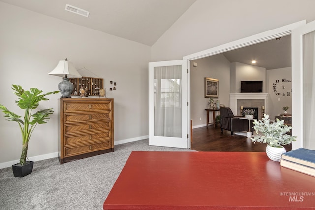 interior space featuring visible vents, a fireplace, baseboards, french doors, and vaulted ceiling