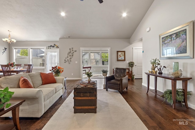 living room with baseboards, recessed lighting, dark wood-style flooring, and ceiling fan with notable chandelier
