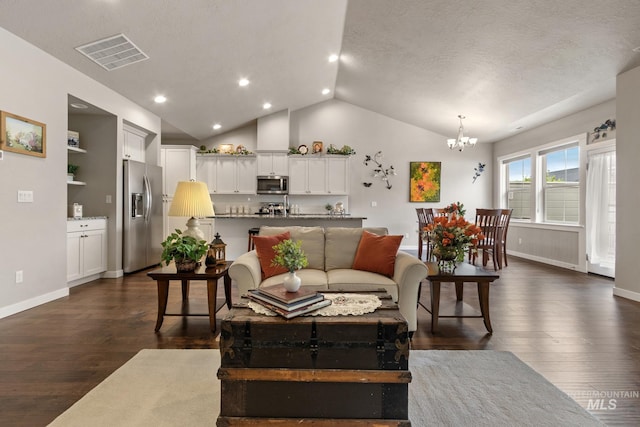 living area featuring a chandelier, visible vents, dark wood finished floors, baseboards, and lofted ceiling