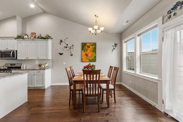 dining room featuring a chandelier, baseboards, lofted ceiling, visible vents, and dark wood-style floors