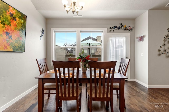 dining space featuring visible vents, dark wood finished floors, and plenty of natural light