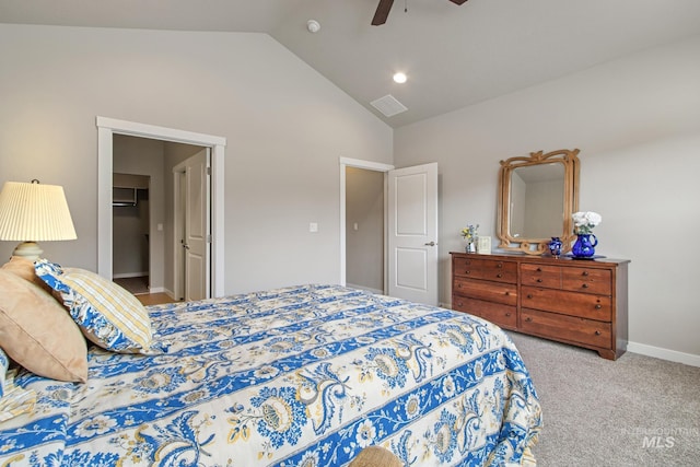 bedroom featuring visible vents, baseboards, a walk in closet, a ceiling fan, and carpet