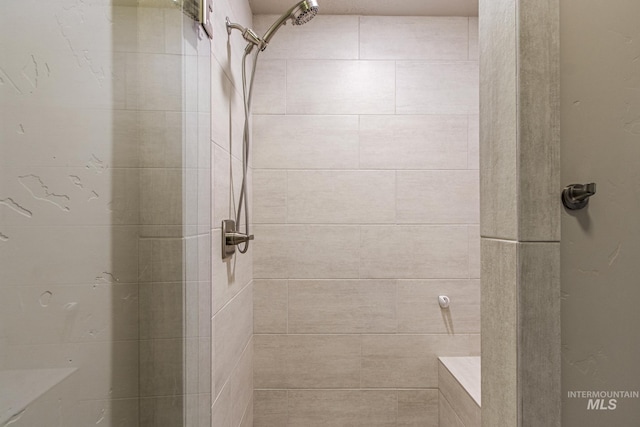 full bathroom with a tile shower