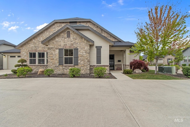 view of front of property featuring an attached garage and stone siding