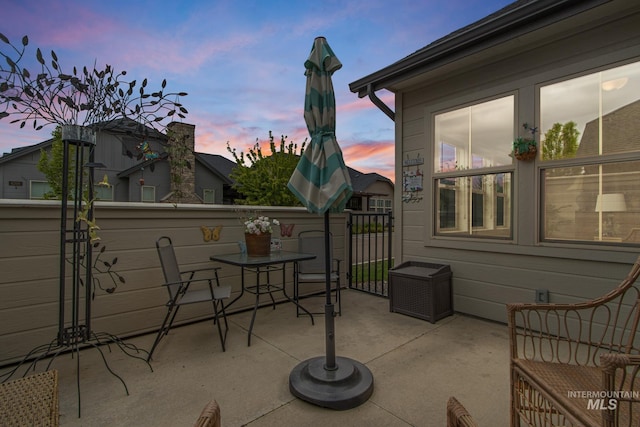patio terrace at dusk featuring outdoor dining area