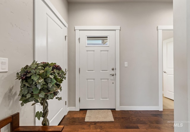 foyer with baseboards and wood finished floors