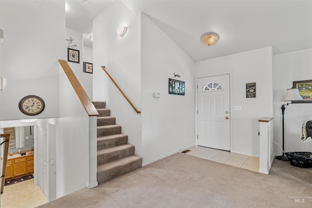 386 E Valleyview Ave, Genesee, ID 83832 - foyer entrance with light carpet, light tile patterned floors, stairway, vaulted ceiling, and baseboards