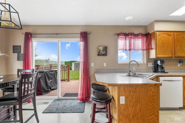 386 E Valleyview Ave, Genesee, ID 83832 - kitchen featuring dishwasher, a sink, a peninsula, a kitchen bar, and light countertops