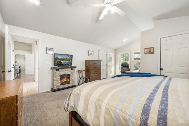 1177 N Lopez Ave, Eagle, ID 83616 - carpeted bedroom featuring vaulted ceiling, a stone fireplace, ceiling fan, and baseboards