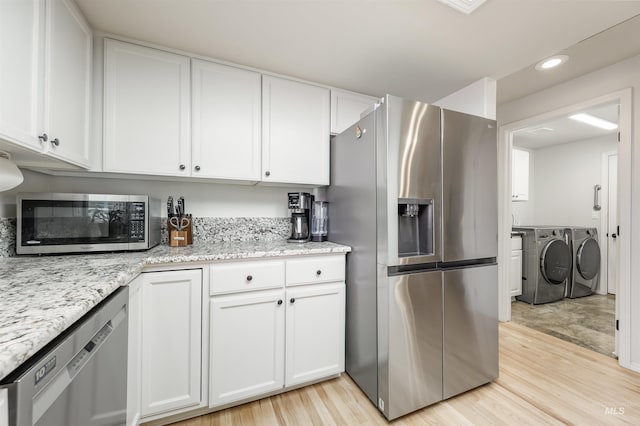 1177 N Lopez Ave, Eagle, ID 83616 - kitchen with stainless steel appliances, washer and clothes dryer, white cabinets, recessed lighting, and light wood-style flooring