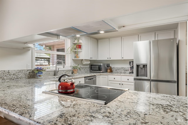 1177 N Lopez Ave, Eagle, ID 83616 - kitchen featuring stainless steel appliances, a sink, white cabinets, and light stone counters