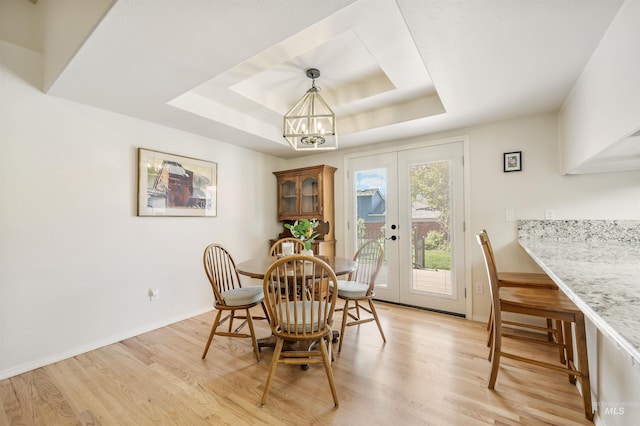 1177 N Lopez Ave, Eagle, ID 83616 - dining space with a tray ceiling, light wood finished floors, a chandelier, and french doors