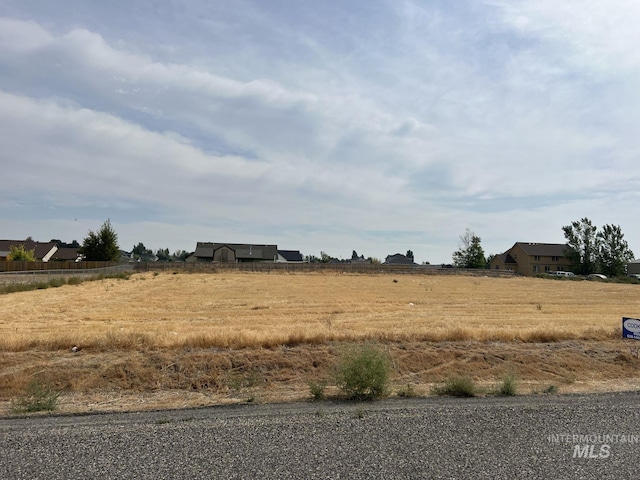 view of yard with a rural view