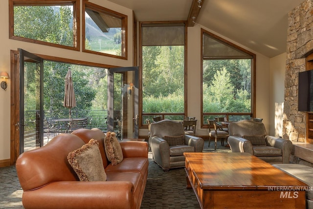 221 Picabo Street #I, Interest 6-C, Ketchum, ID 83340 - living room featuring high vaulted ceiling, dark carpet, beamed ceiling, and a stone fireplace