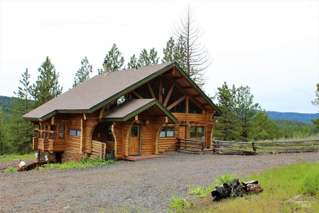 log home featuring a mountain view and covered porch