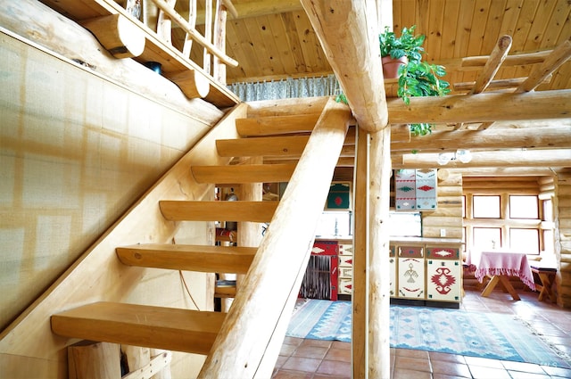 stairway featuring log walls and light tile floors