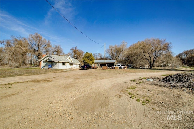 view of street featuring dirt driveway