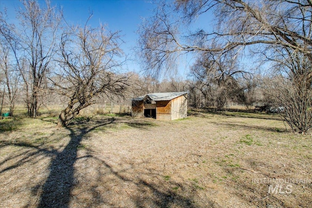 view of yard with an outbuilding and a storage shed