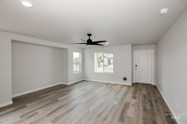 empty room with light hardwood / wood-style floors and ceiling fan