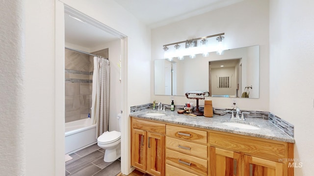 full bathroom featuring toilet, double vanity, a sink, and shower / bath combo with shower curtain