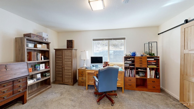 carpeted office with a barn door