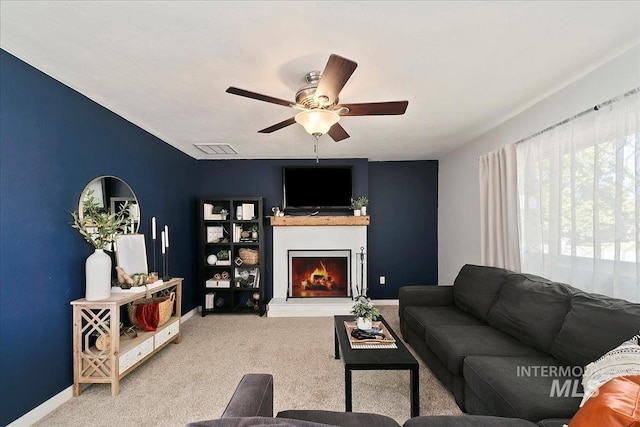 living room featuring carpet floors and ceiling fan