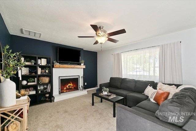 carpeted living room with ceiling fan