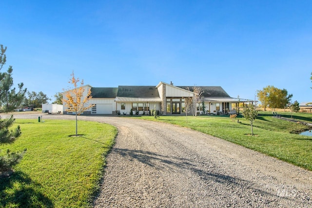 ranch-style home with covered porch, a front lawn, and a garage