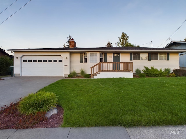 ranch-style house with a garage and a front lawn