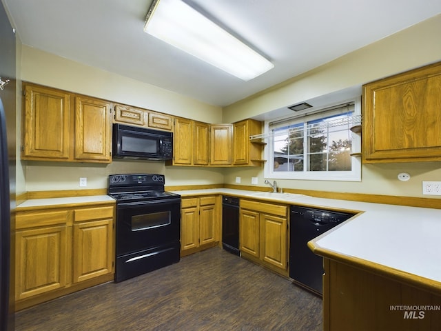 kitchen with sink, dark hardwood / wood-style flooring, and black appliances